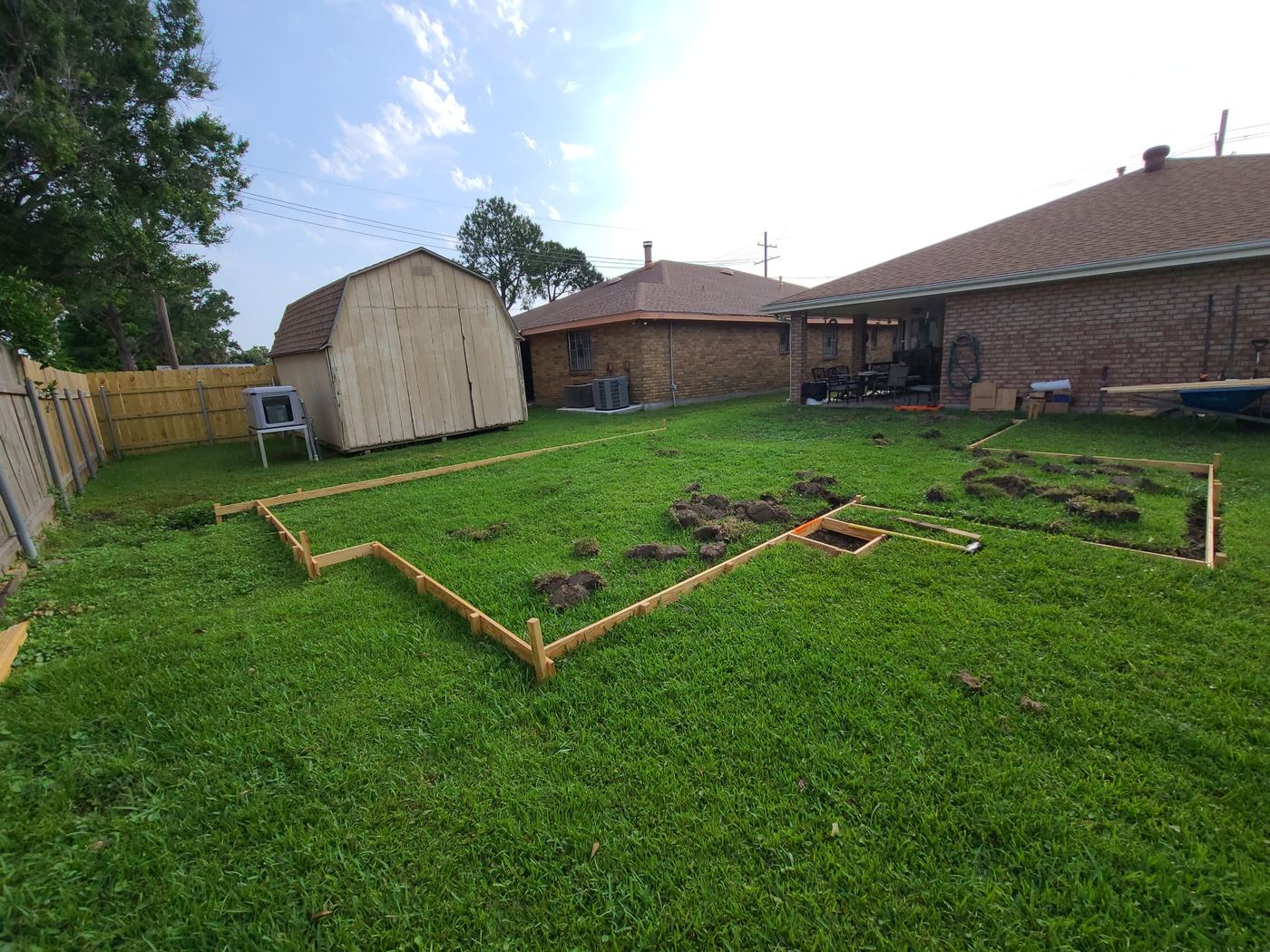 Step 1 of 14, Layout: Forms staked out on the lawn to mark the pool, sun shelf, and spa.