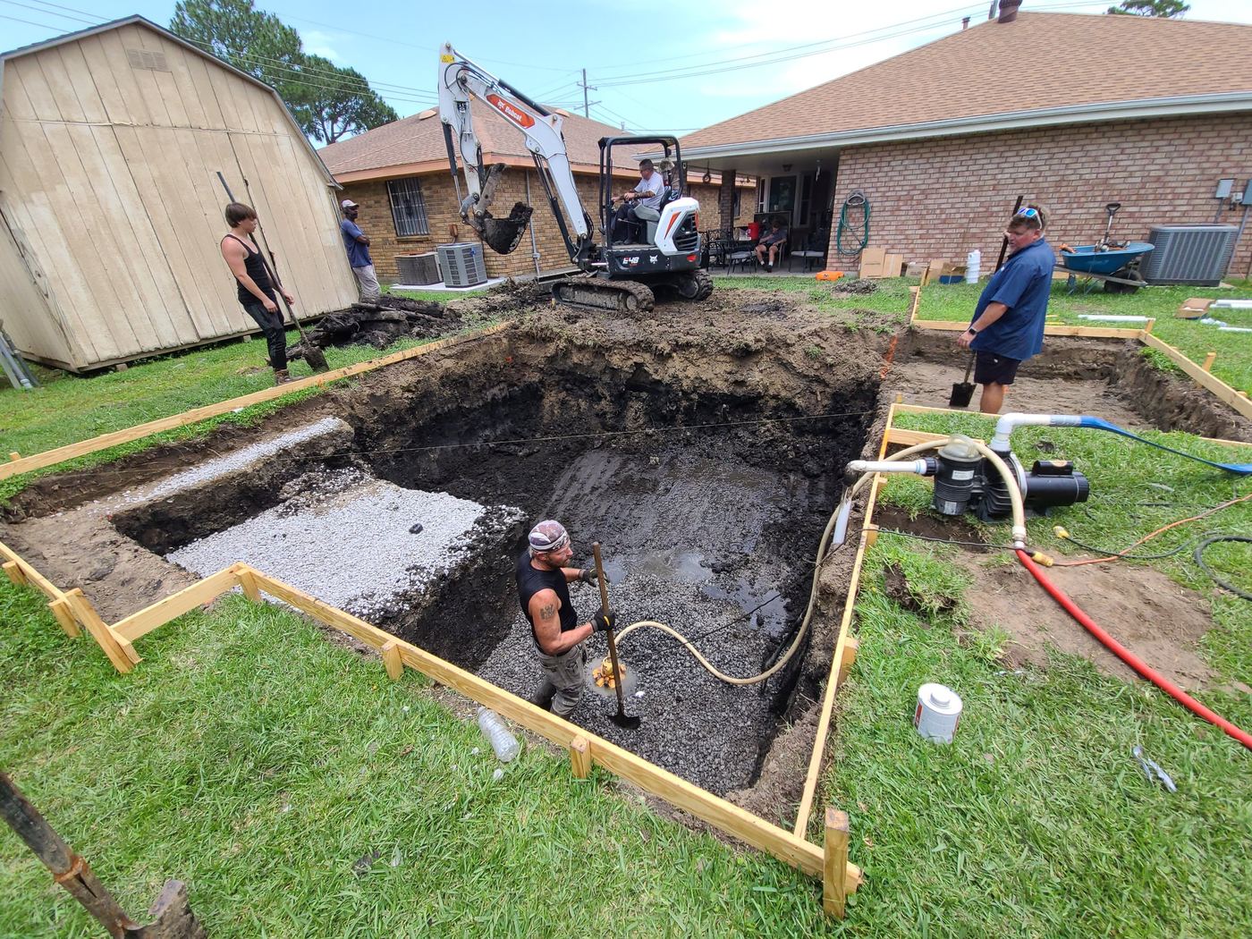 Step 2 of 14, Dig: Excavation begins, with a pump keeping groundwater out of the hole.