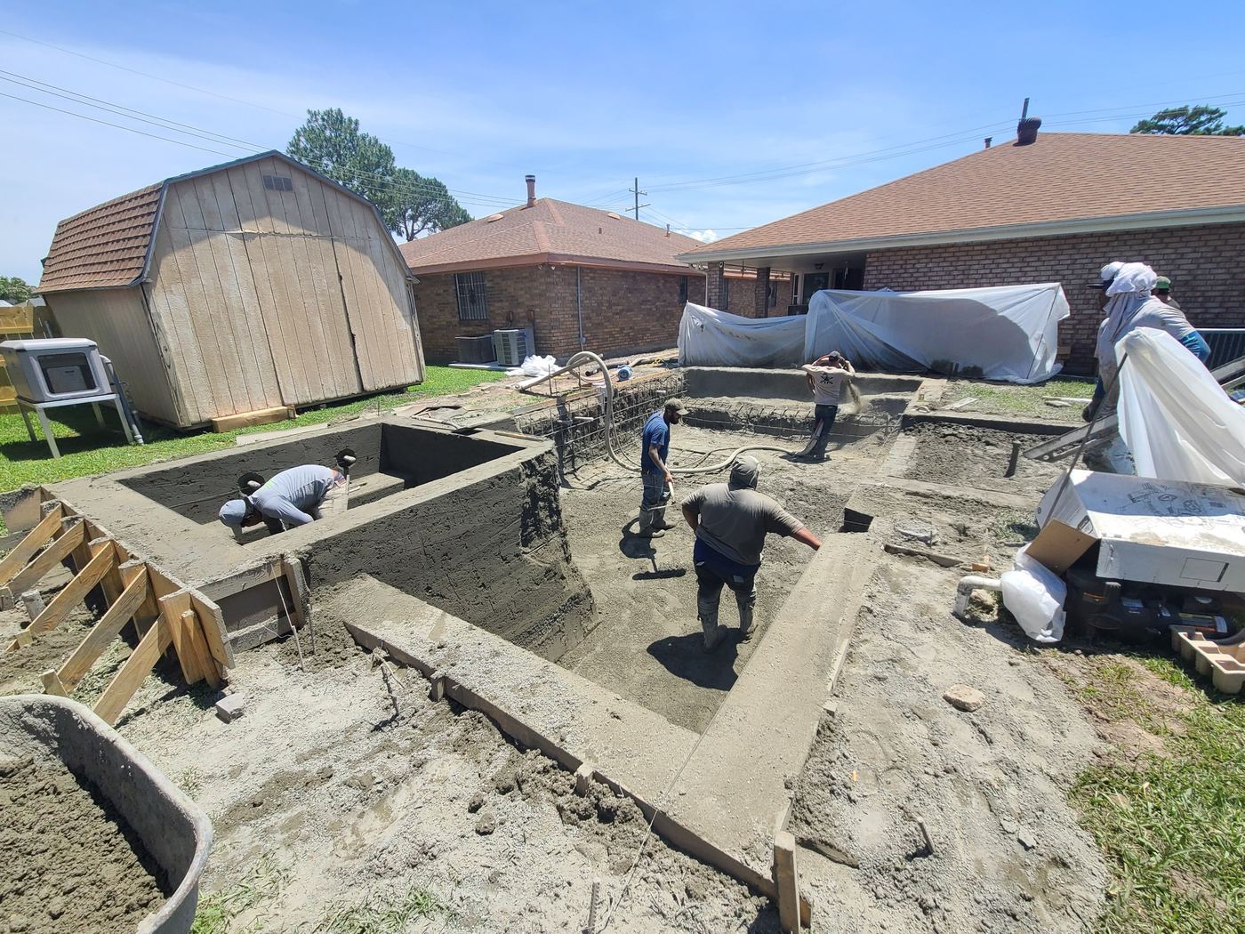 Step 7 of 14, Gunite: Walls, steps, and sun shelf shaped by hand.