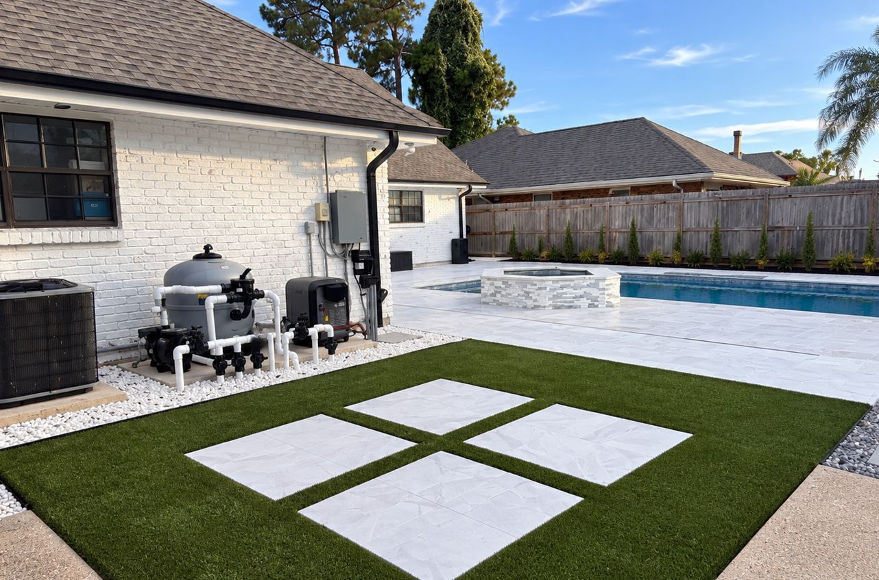 Pool equipment pad with filter, pump, heater, and valves beside the house, with the pool, raised spa, and turf with stone pavers nearby