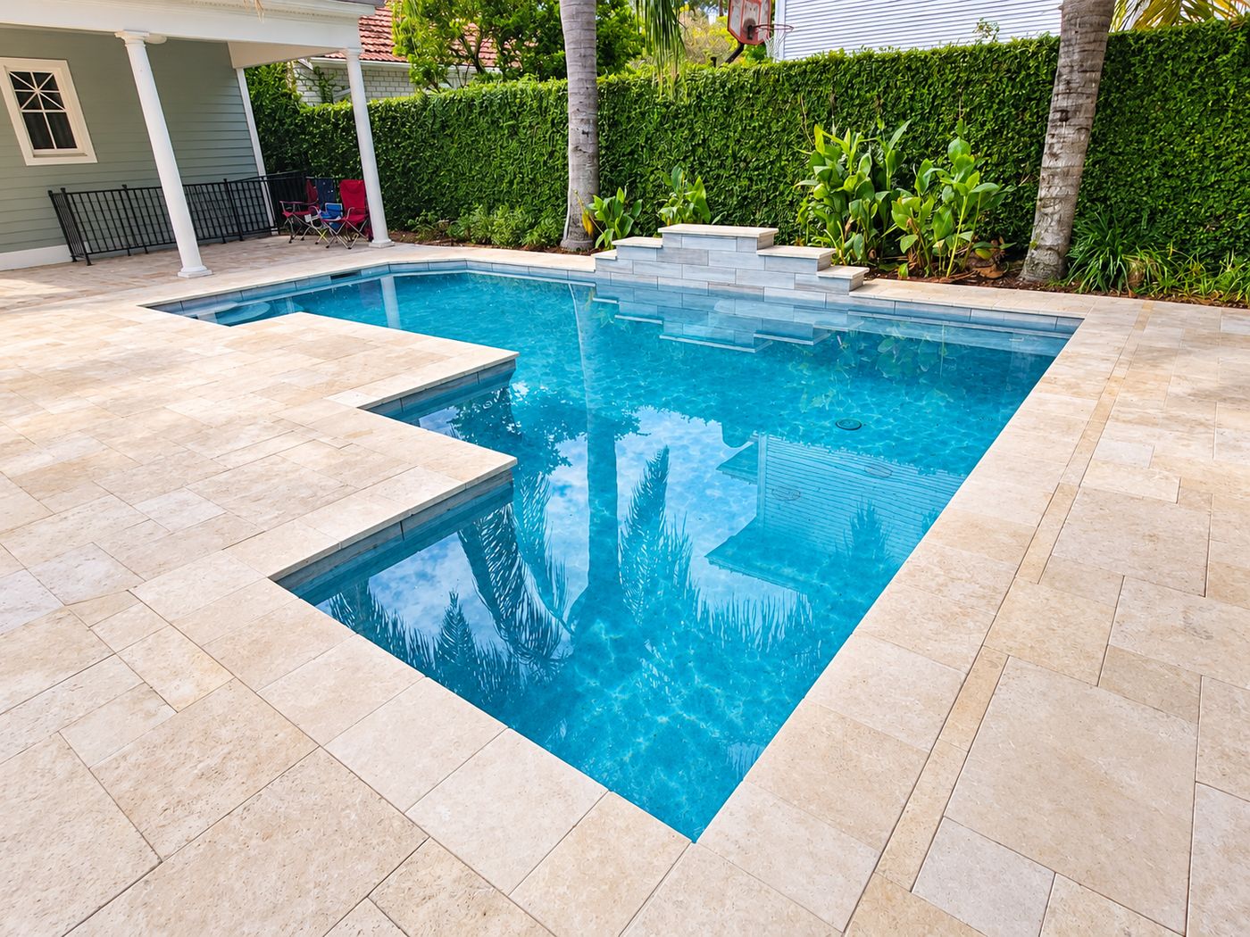 Travertine pool deck and coping around a backyard pool