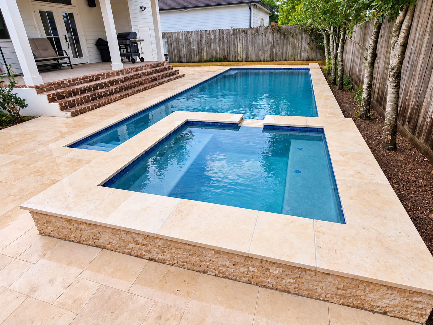 Pool with raised spa in a narrow backyard